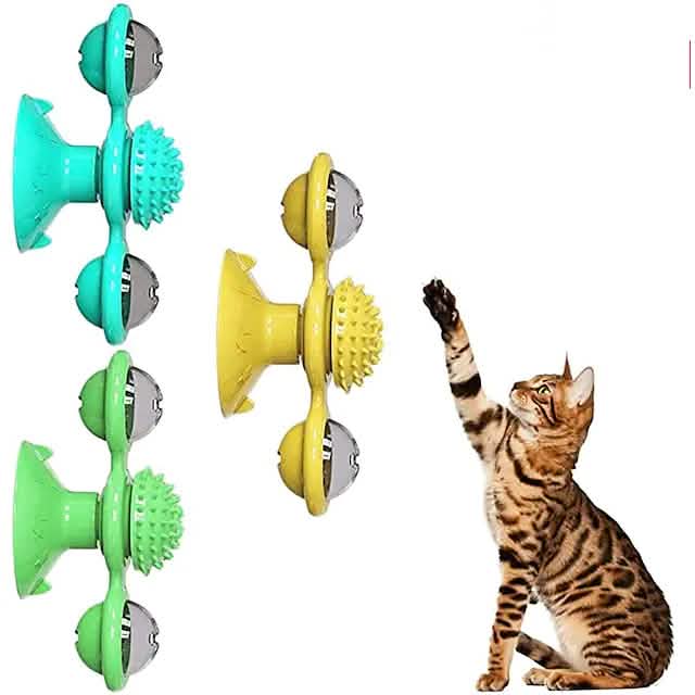green, blue and yellow toys with cat looking at them