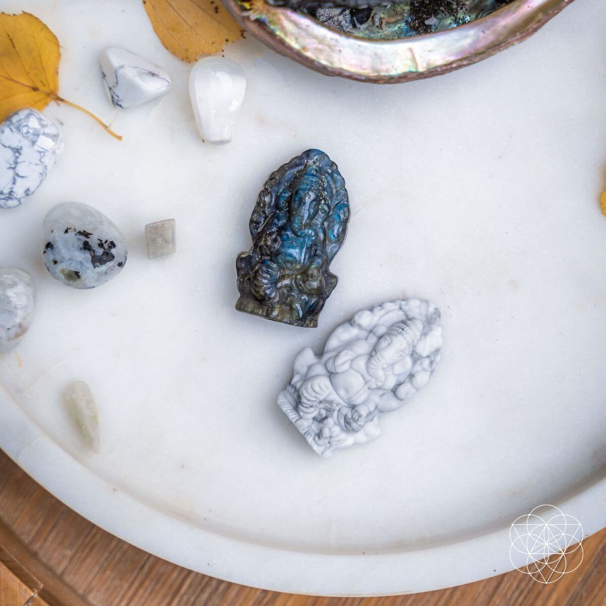 Mineral specimens on a white surface with a decorative bowl.