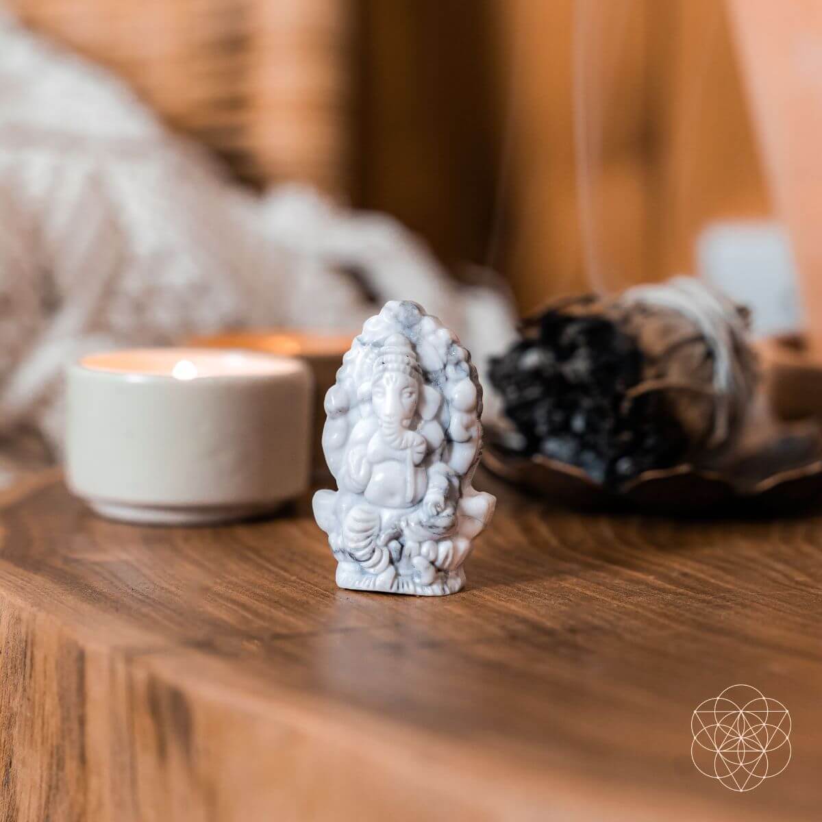 Small Howlite stone statue on a wooden surface with a blurred background