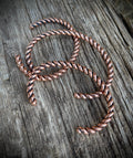 Twisted copper wire on a wooden surface