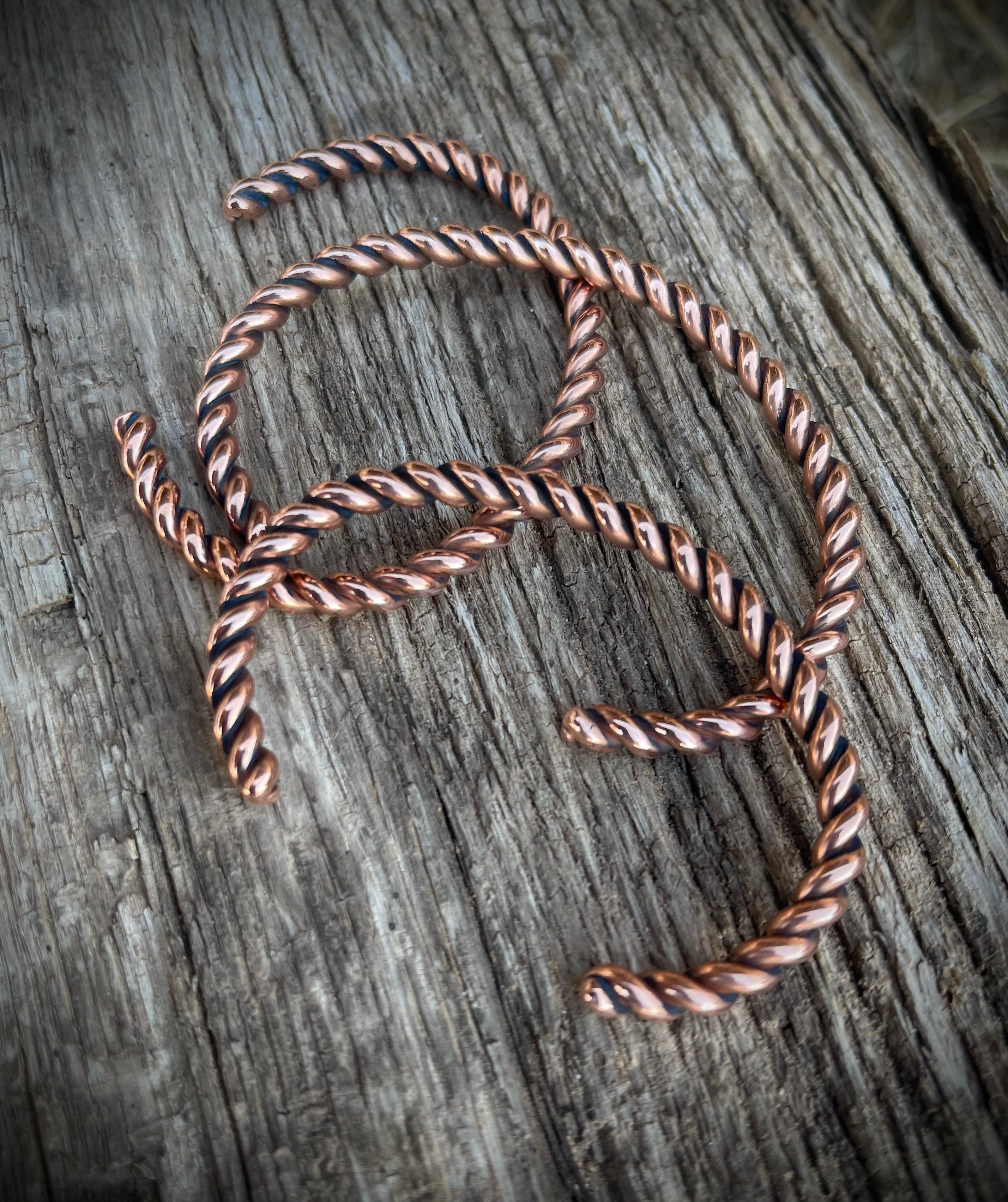 Twisted copper wire on a wooden surface