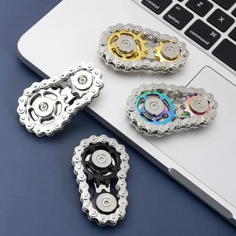 Four metallic gear-shaped objects on a laptop keyboard