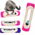 cat playing with textured tube with balls inside.