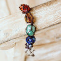 Tassel with colorful stones on a wooden surface
