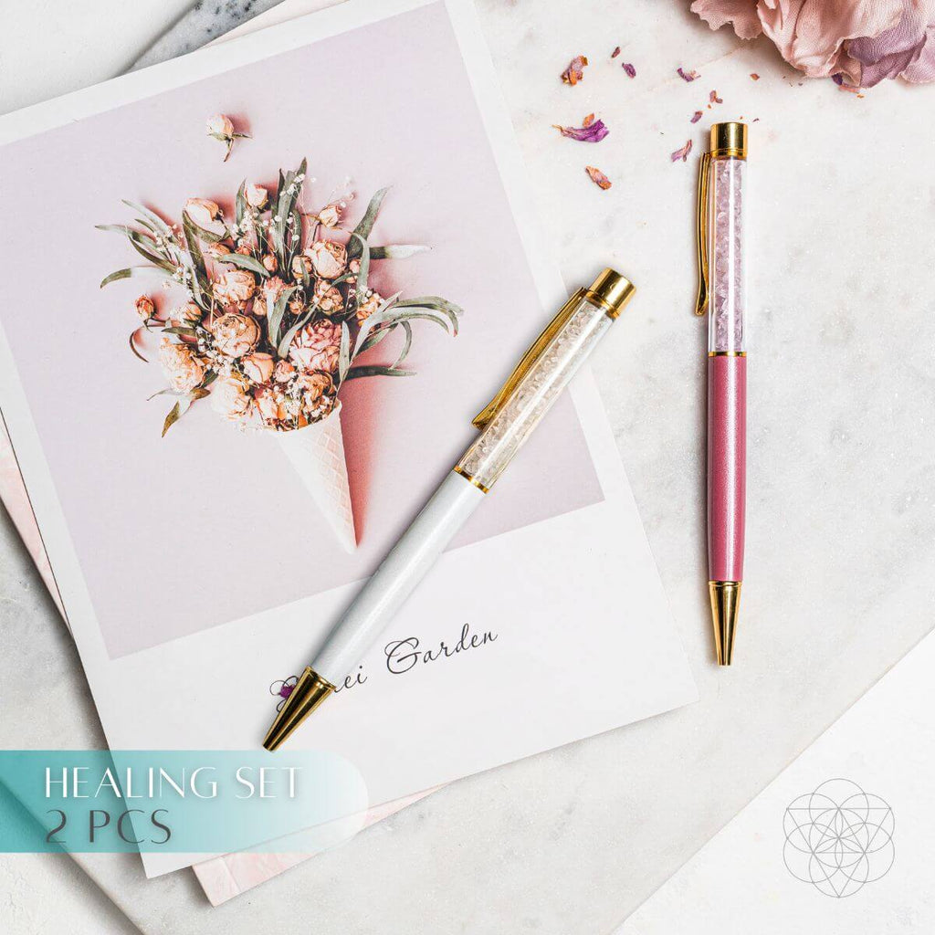 Two decorative pens on a surface with floral design and text